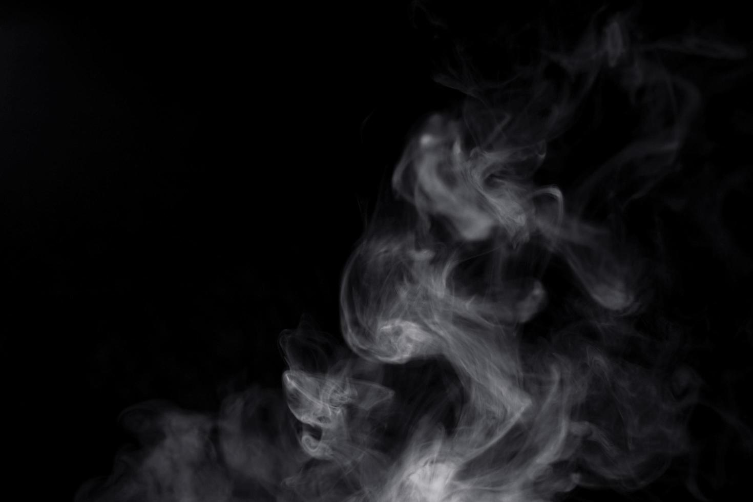 white smoke on black background for overlay effect. a realistic smoke effect for creating an intense nuance in a photo