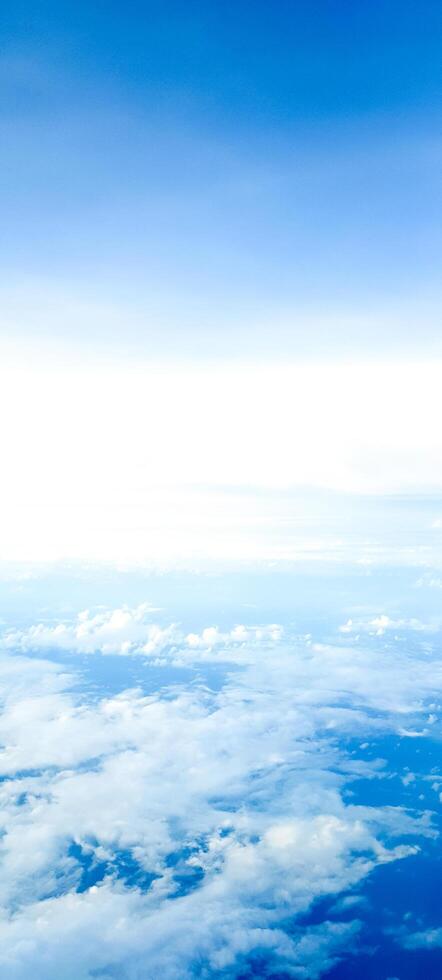 a beautiful view of the sky from a plane point of view. fascinating white clouds in the sky. what you will see when you are flying. beauty of the stratosphere. photo