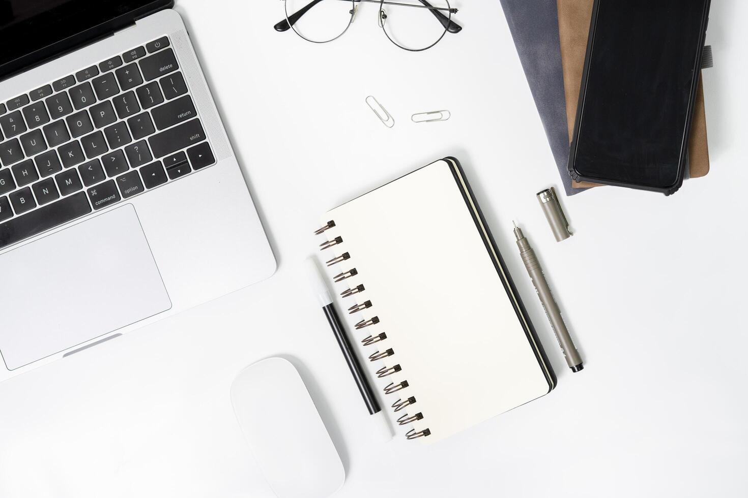 office starter pack on desk from top point of view. office stationery isolated on white background. desk copy space collection for work or office. photo