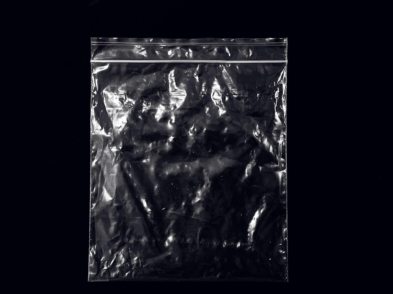 a transparent plastic bag isolated on black background. empty or blank plastic for mockup and template. layout for advertisement or promotion. photo