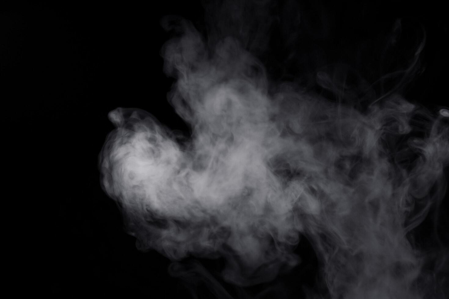 white smoke on black background for overlay effect. a realistic smoke effect for creating an intense nuance in a photo