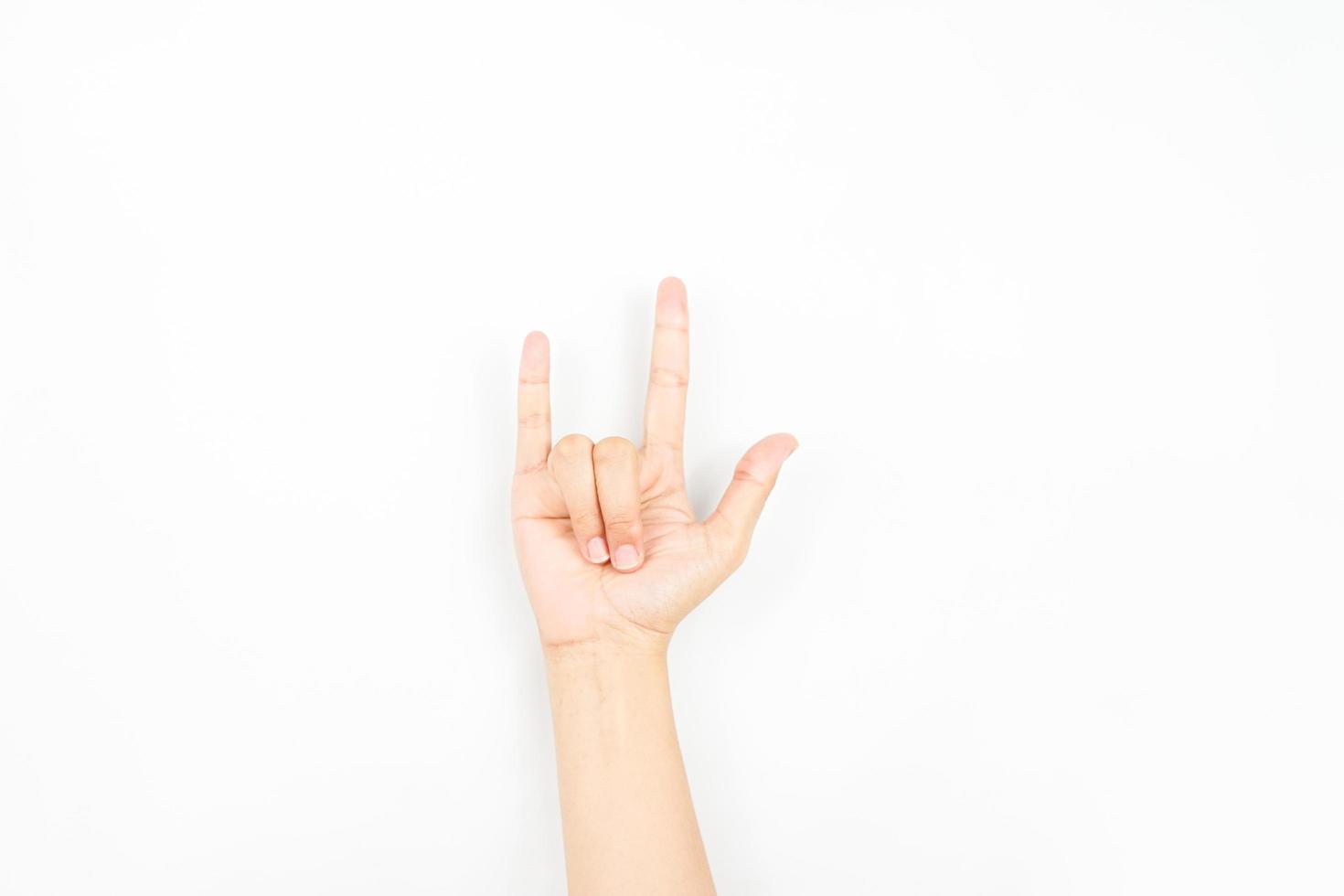 a hand gesture that is usually used to symbolize rock genre or metal. collection of the sign language using hand gestures. photo