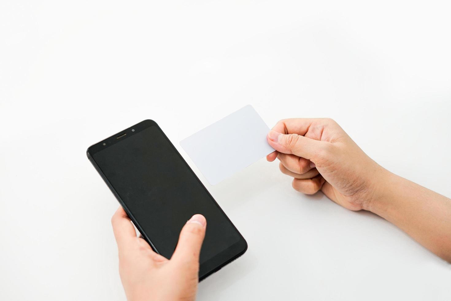 hands are holding a phone in the left and an empty card in the right. a graphic resource for mockup. photo