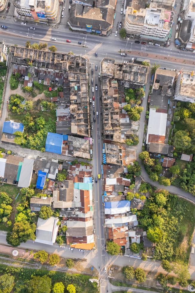 Top view of commercial building and crowded village and car on the alley in suburban photo