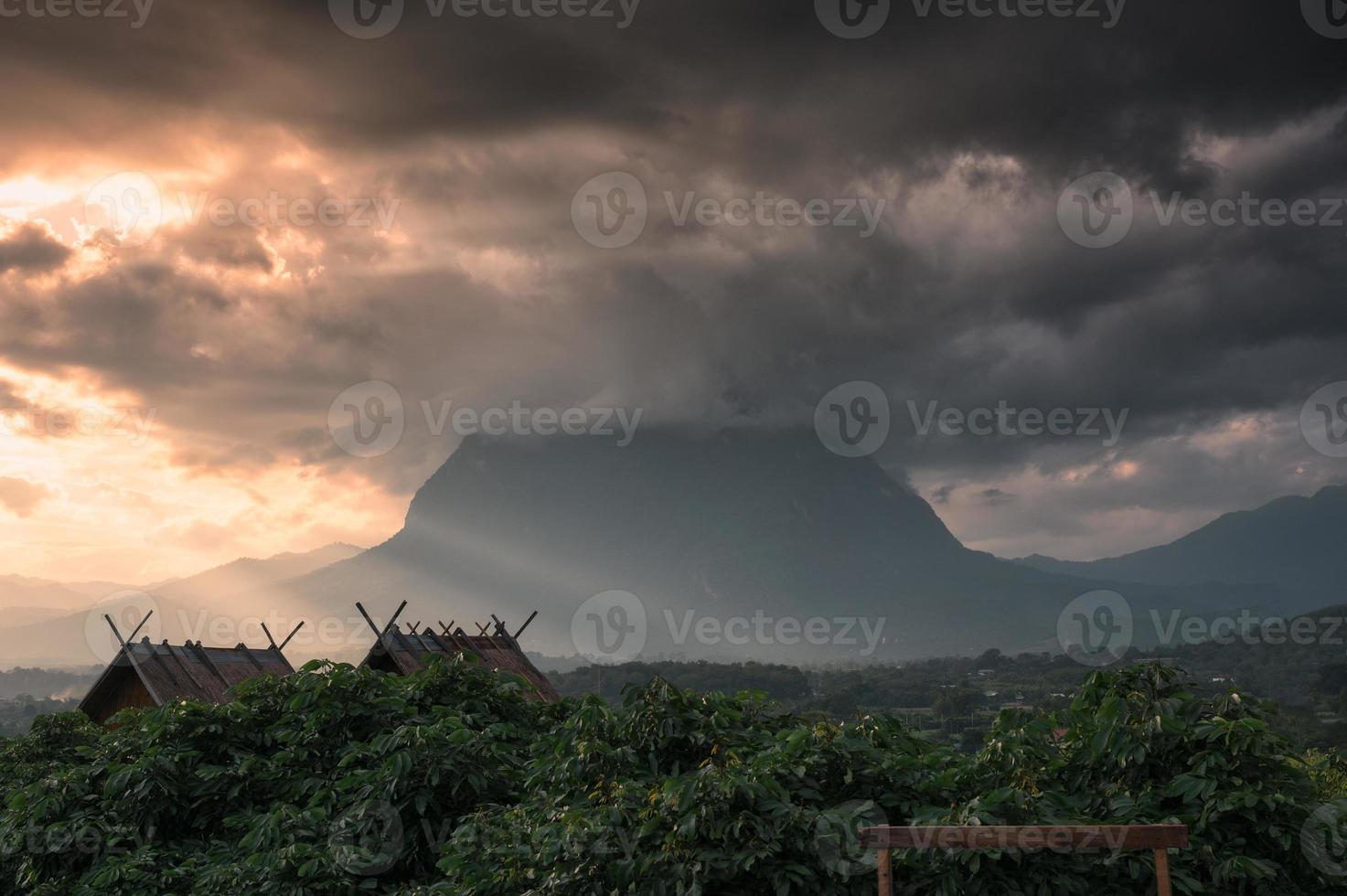 View of Doi Luang Chiang Dao mountain with sunbeam shine and clouds covered in the evening photo