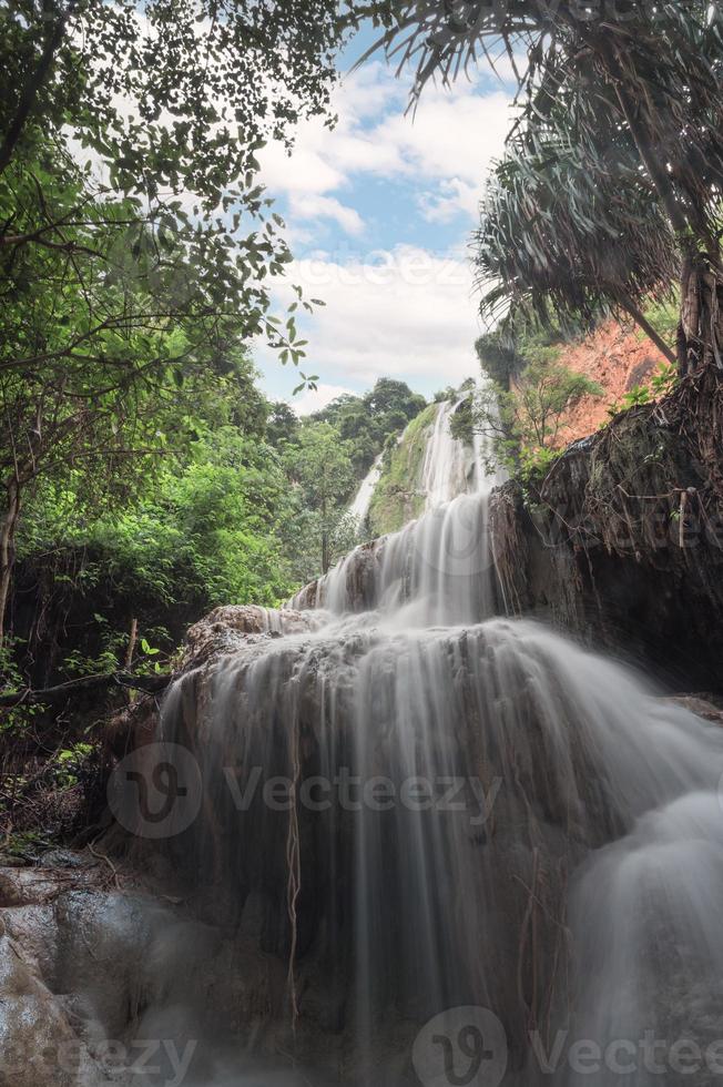 Erawan waterfall 7th floor with water flowing in tropical rainforest at national park photo