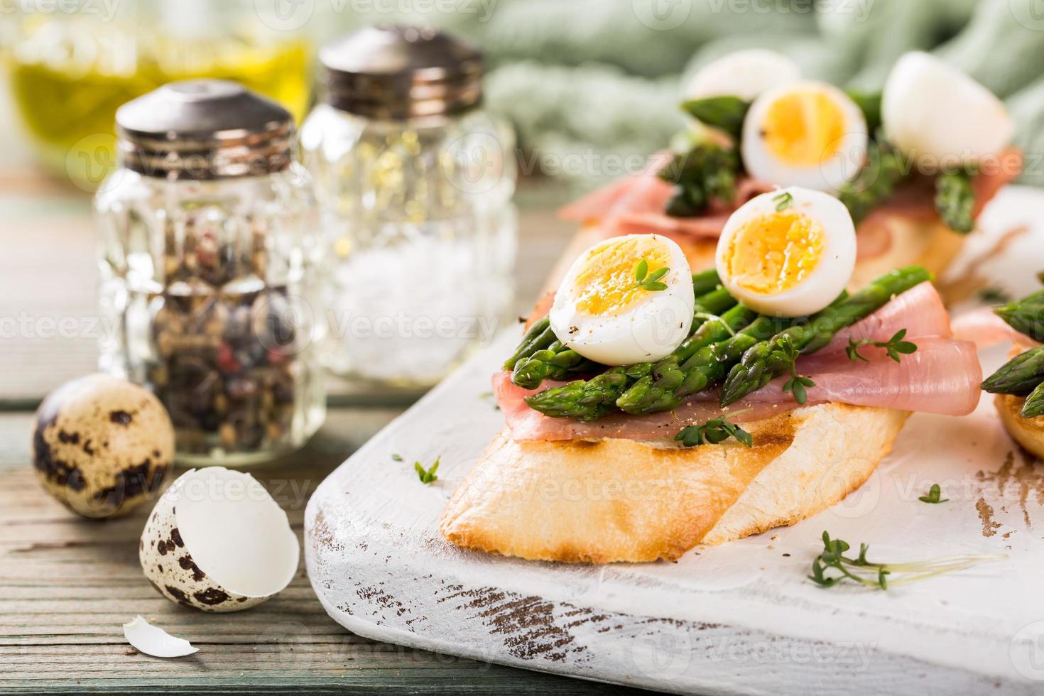 Fresh sendwich with ham, asparagus and quail eggs photo