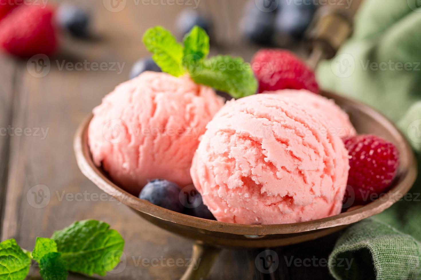 Raspberry ice cream in copper bowl. photo