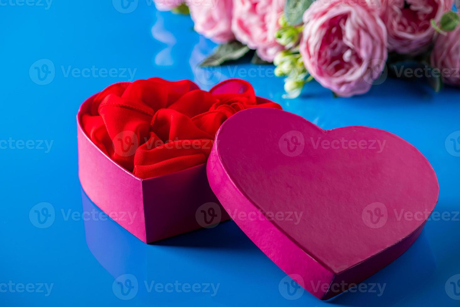 Heart shaped open gift box on blue background. 4694564 Stock Photo at