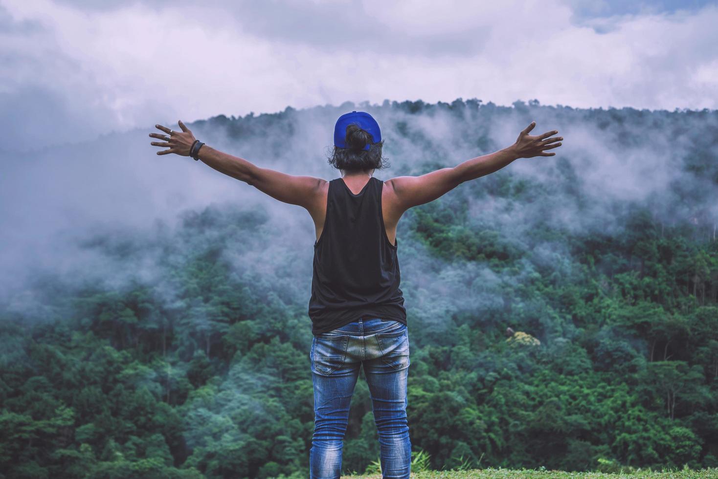 Asian man travel relax in the holiday. Wild nature wood on the mountain. photo