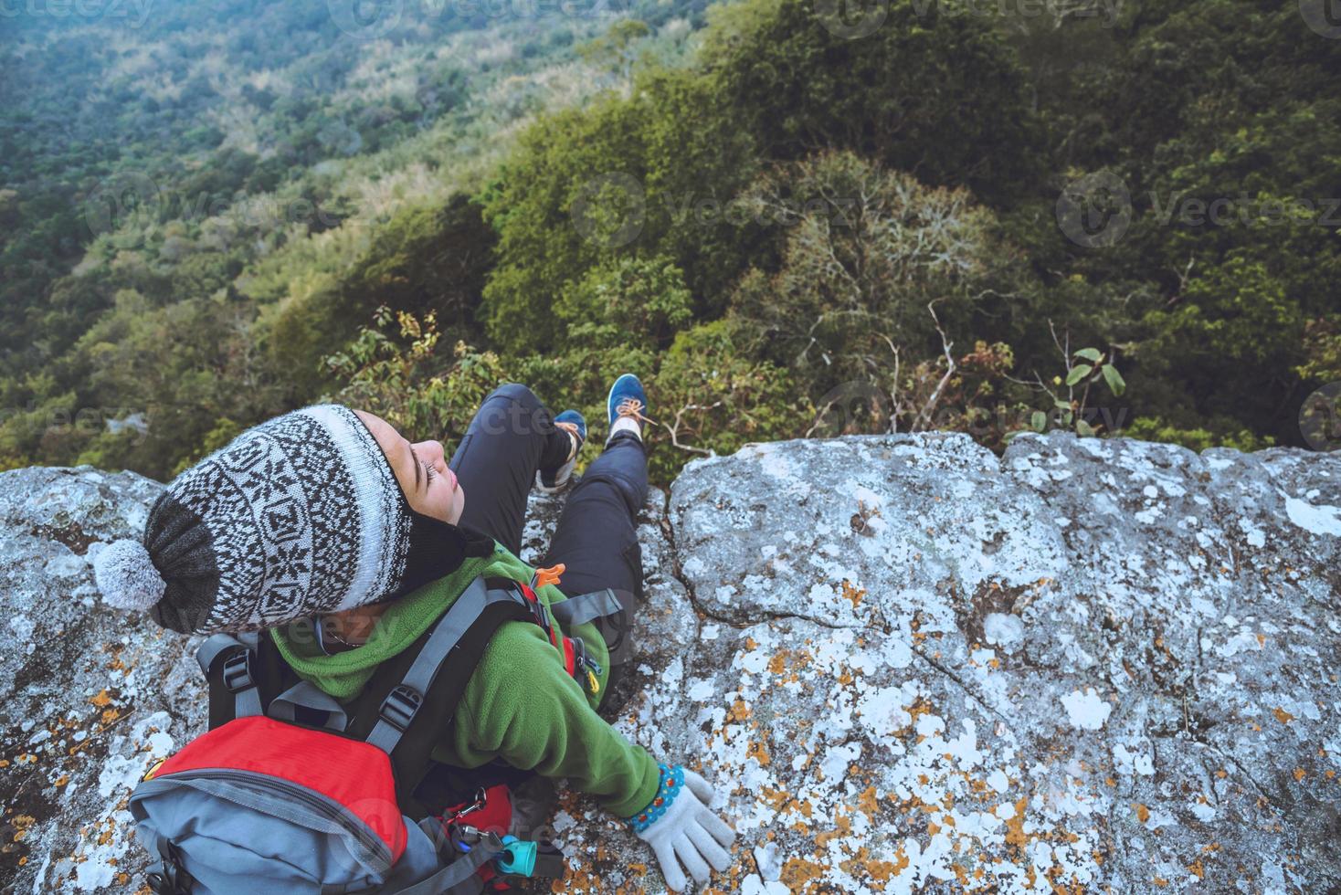 Asian women travel nature. Travel relax. watch mountain view. On a cliff on the mountain. Thailand photo