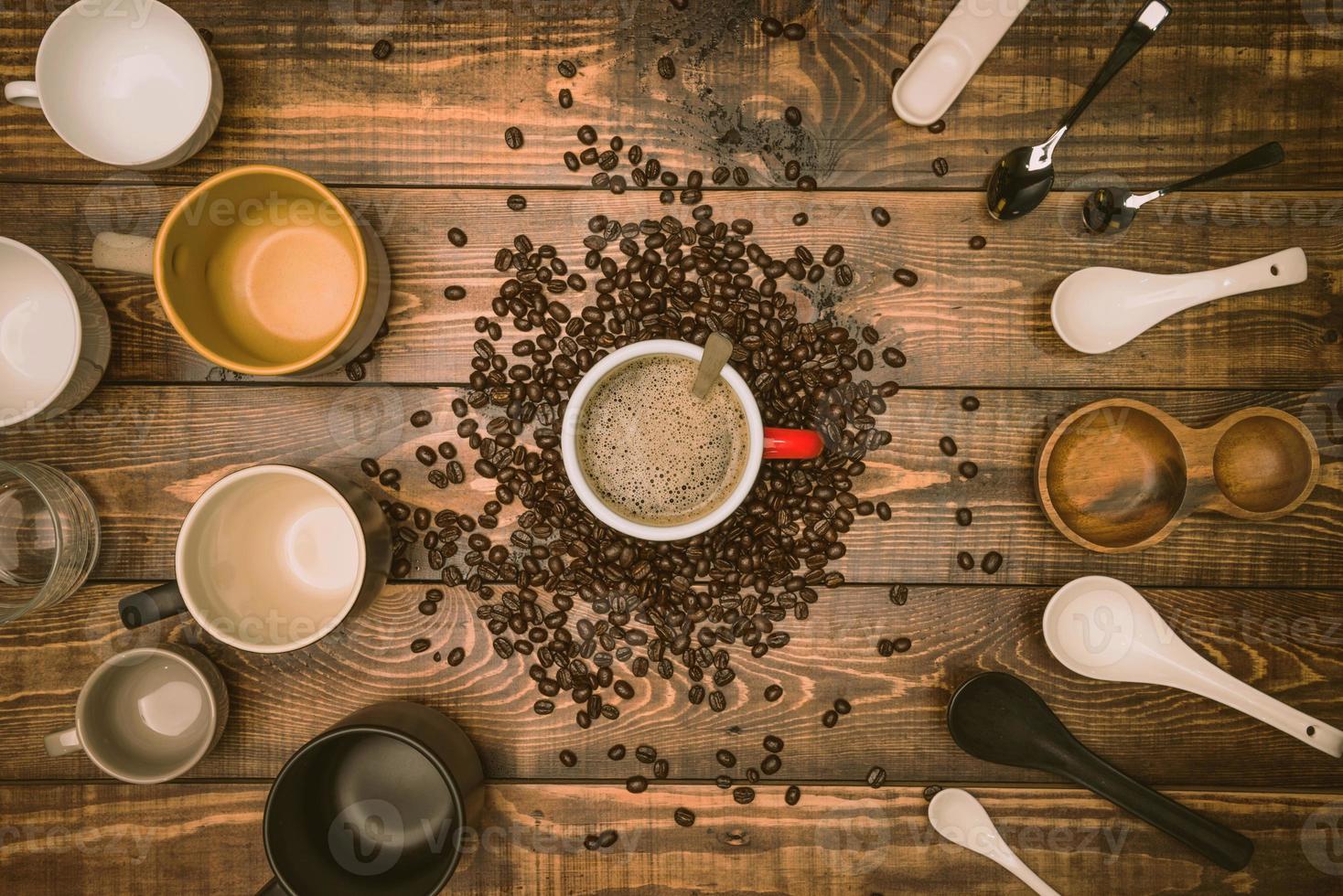 Many cups of coffee with beans on wooden table, top view. Flat lay composition with cups of coffee on background Old wood grain. Food photography, beverage. photo