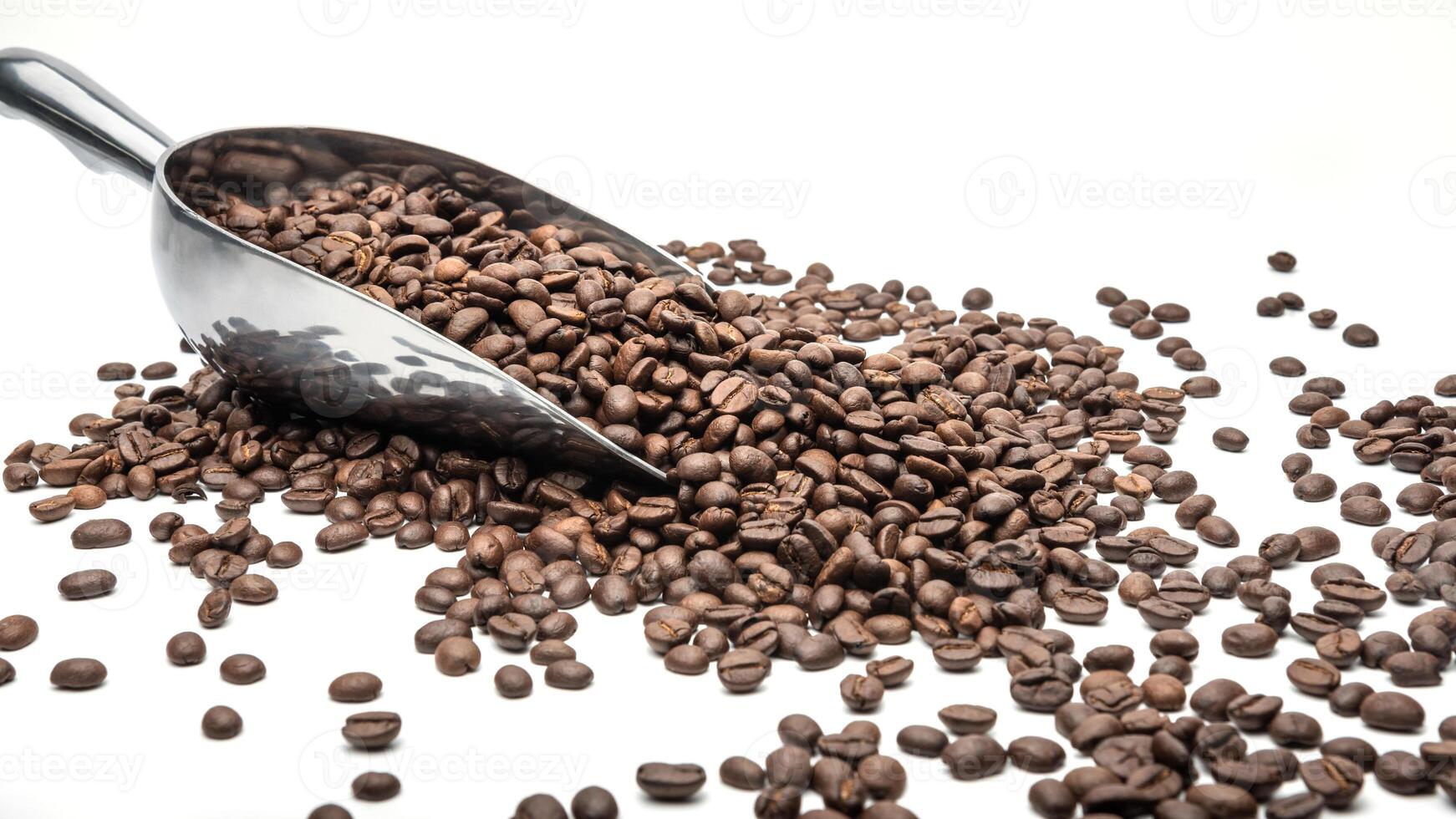 Spoon Coffee scoop and coffee beans roasted on a white background with copy space for your text photo