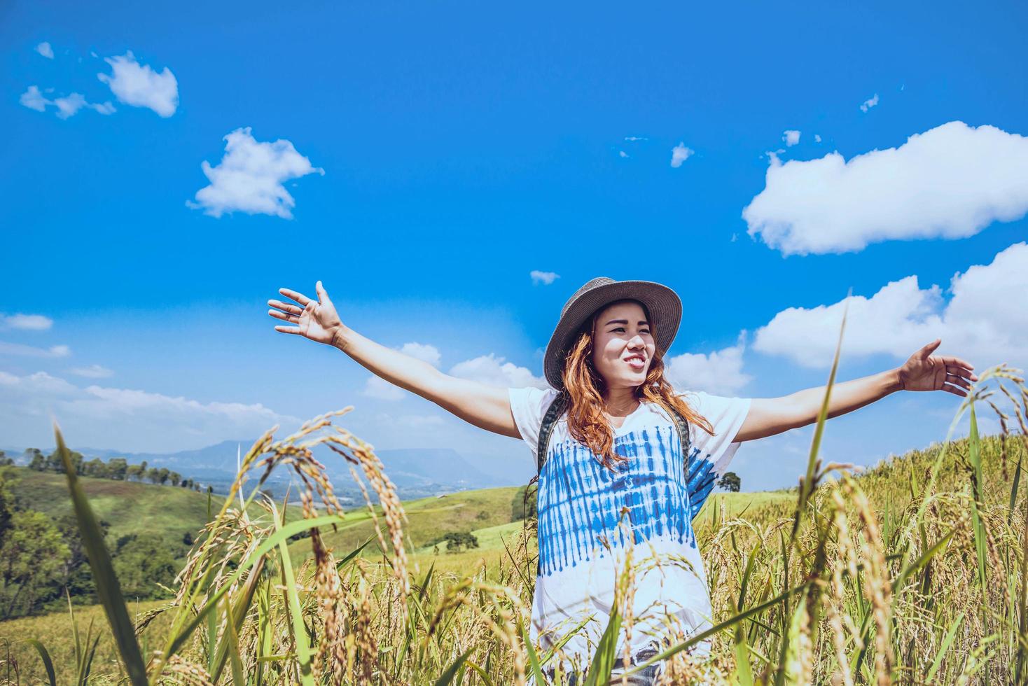 Asian women travel relax in the holiday. Stand natural touch mountain field. Thailand photo