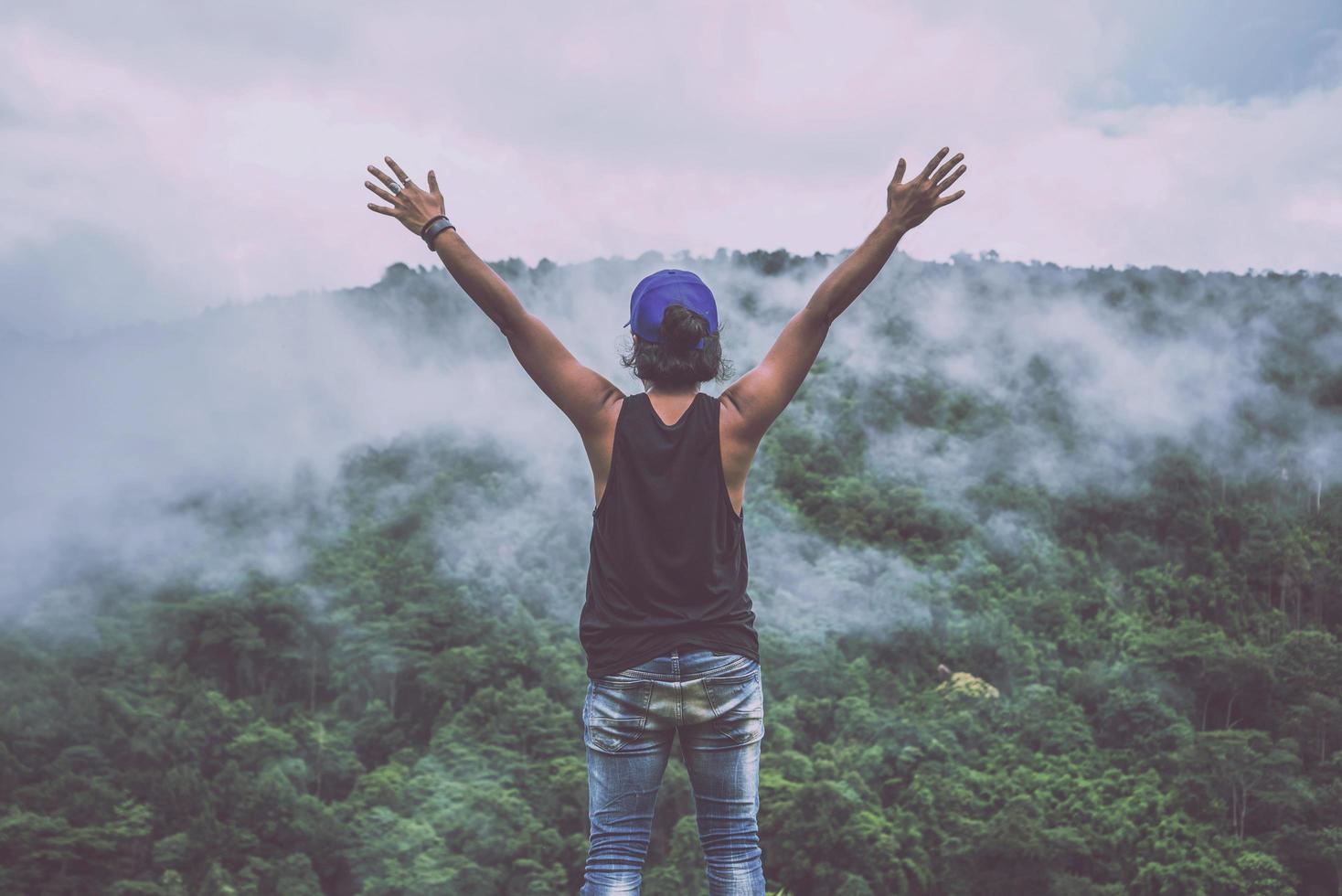 Asian man travel relax in the holiday. Wild nature wood on the mountain. photo