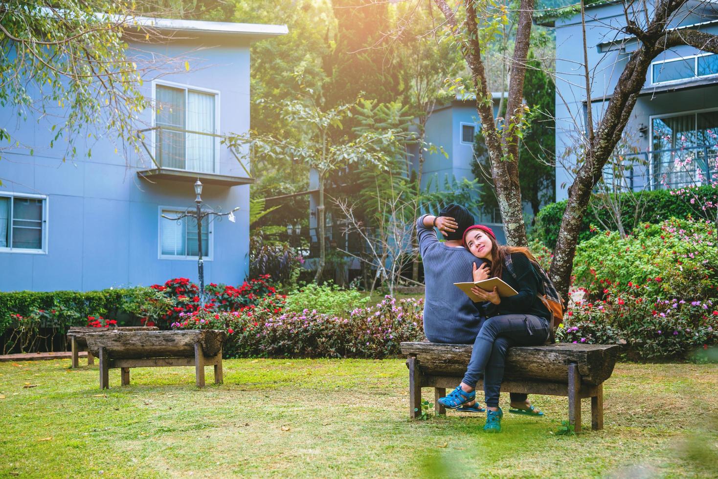 Asian couple smiled and was happy with the book read. Among the beautiful flower gardens, Valentine photo