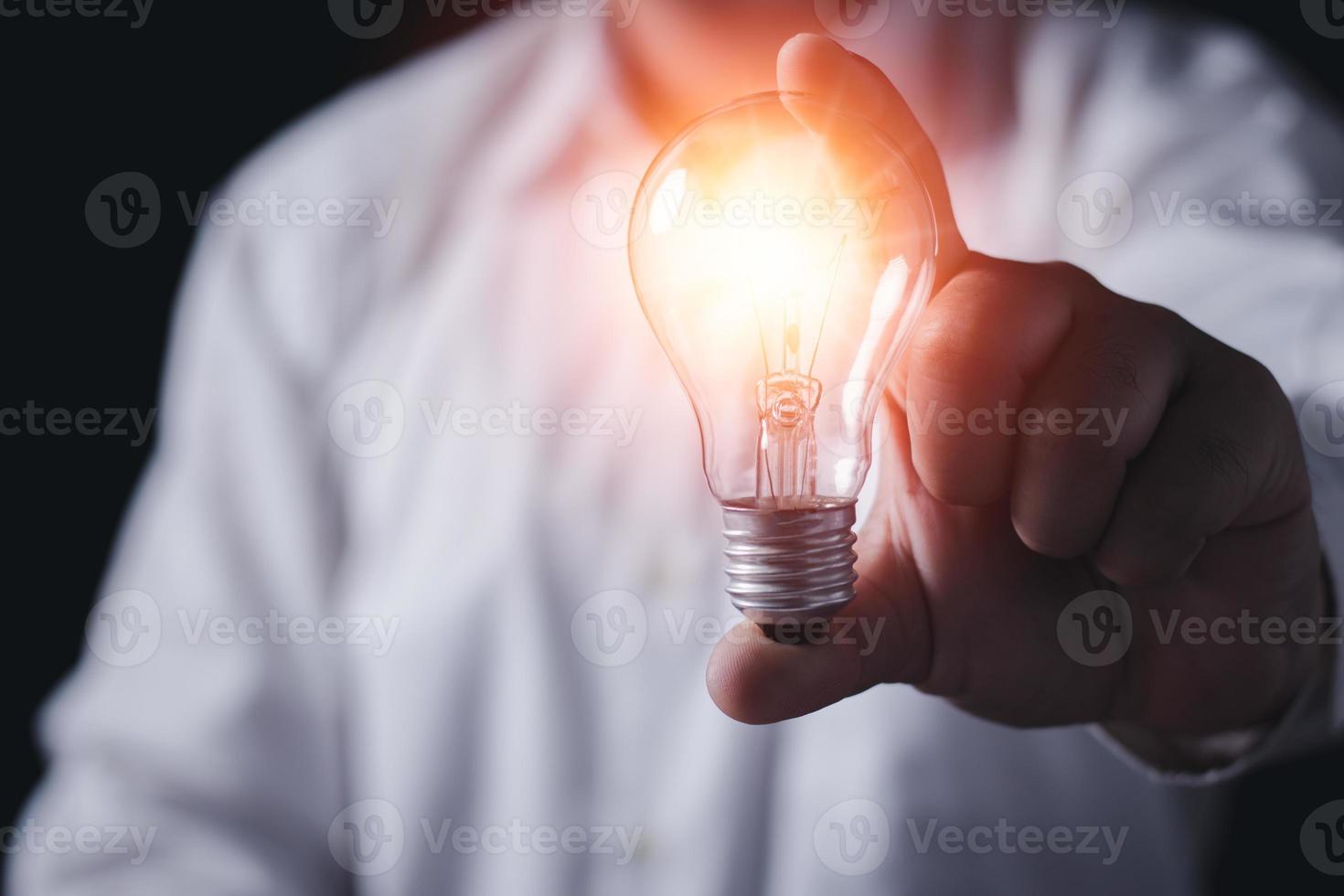 The hand of a man with a light bulb, The idea concept. photo