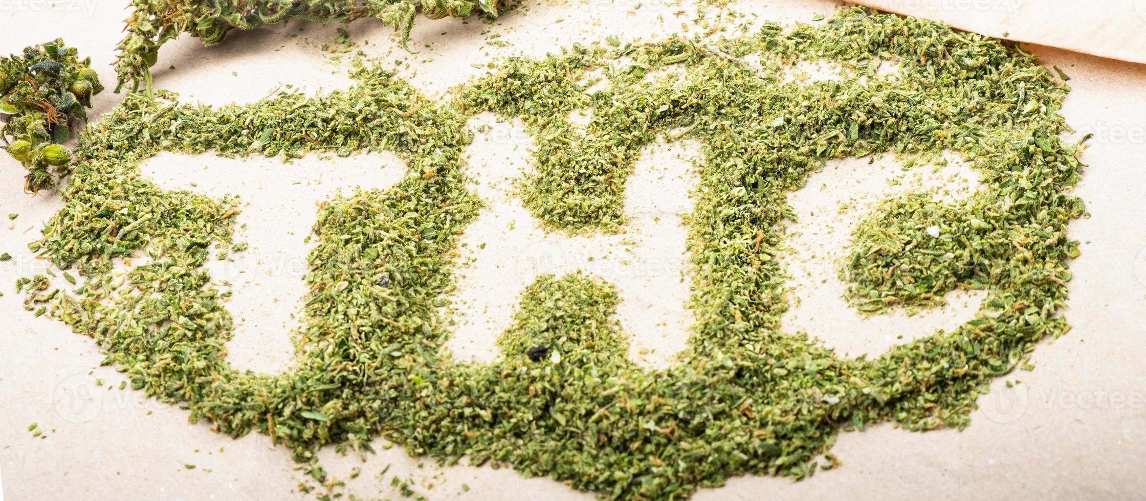 THC lettering on green shredded marijuana buds medical cannabis photo