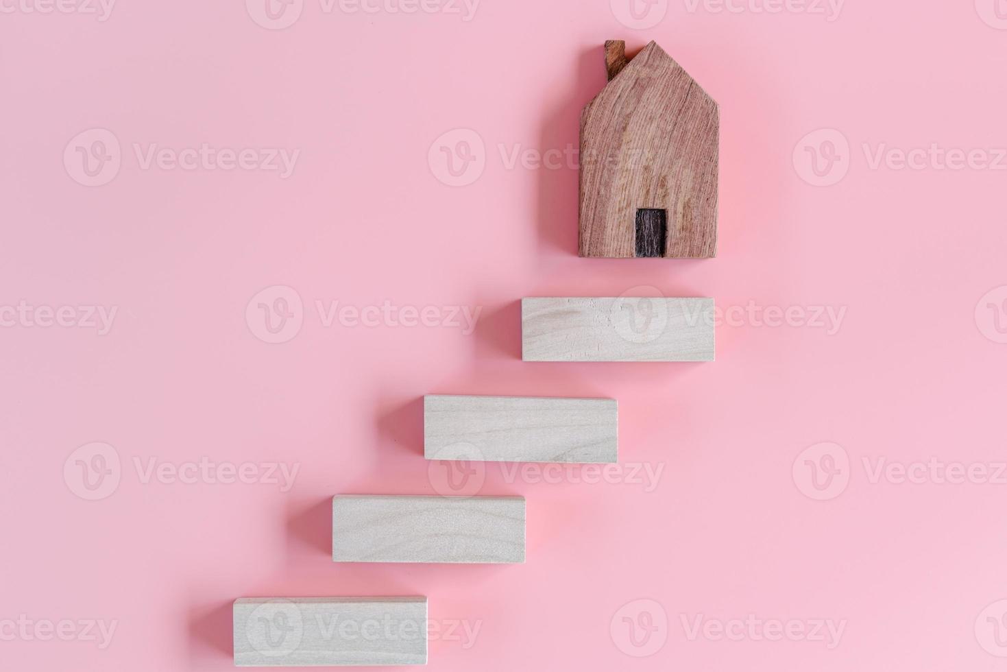 Stair Ladder to Success of Business Strategic, Goal Target Development to Success. Wooden Stair With House Model on Pink Background. Steps Vision Plan to Success in The Future photo
