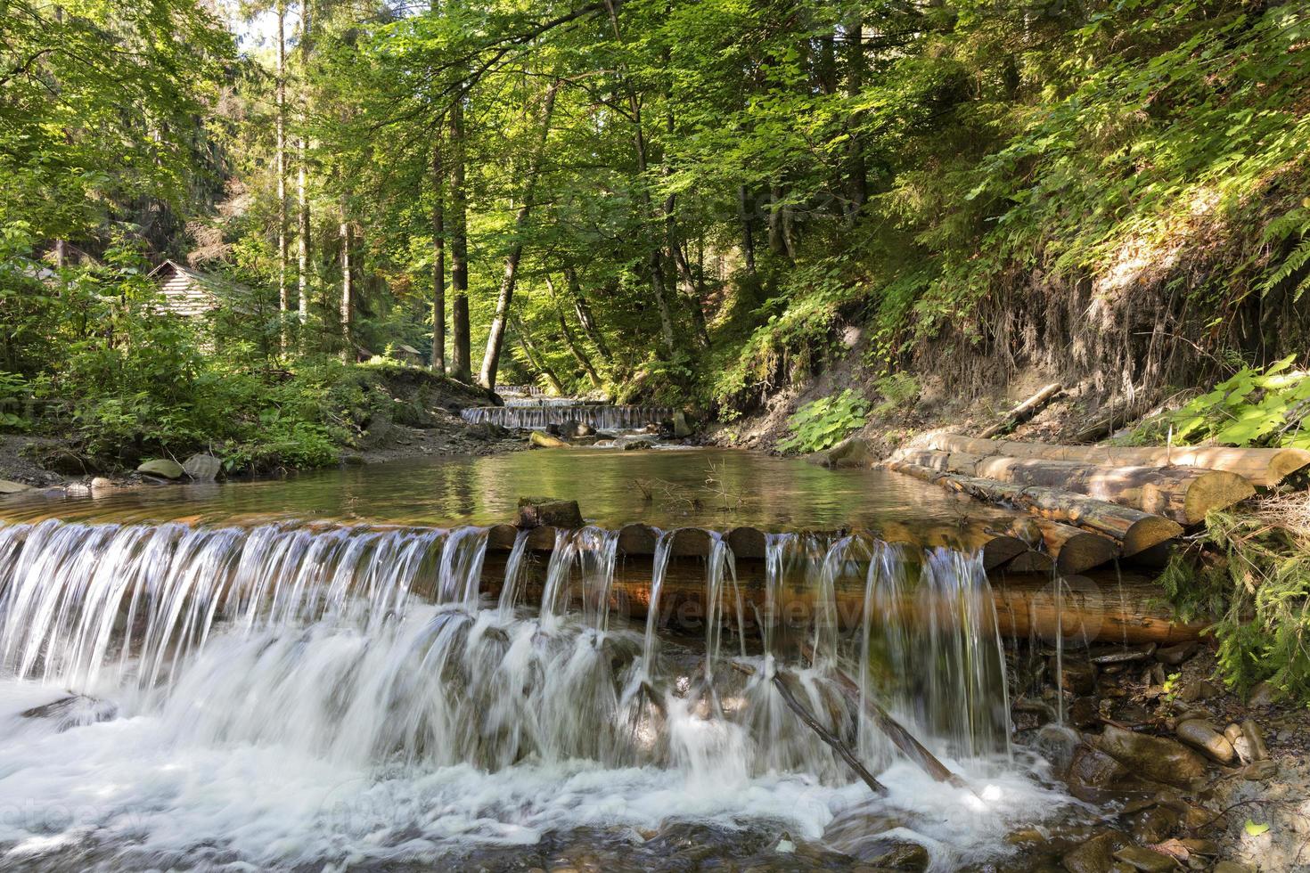 Cascading waterfall of a mountain stream in the Carpathians photo