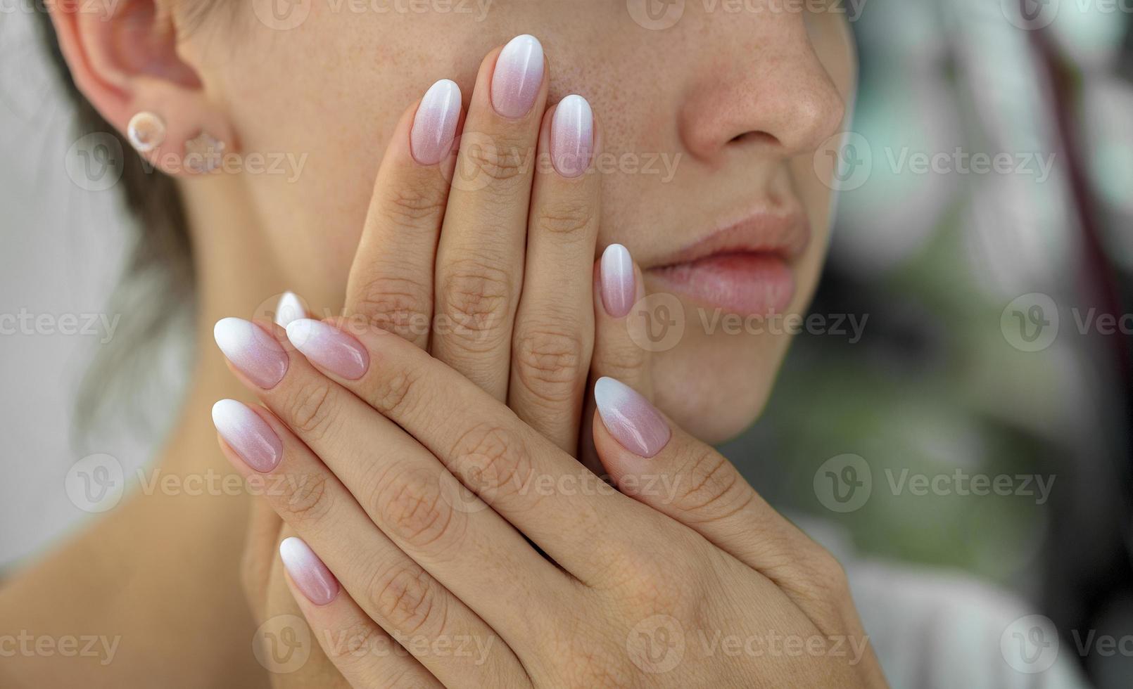 Beautiful woman's nails with beautiful french manicure ombre photo