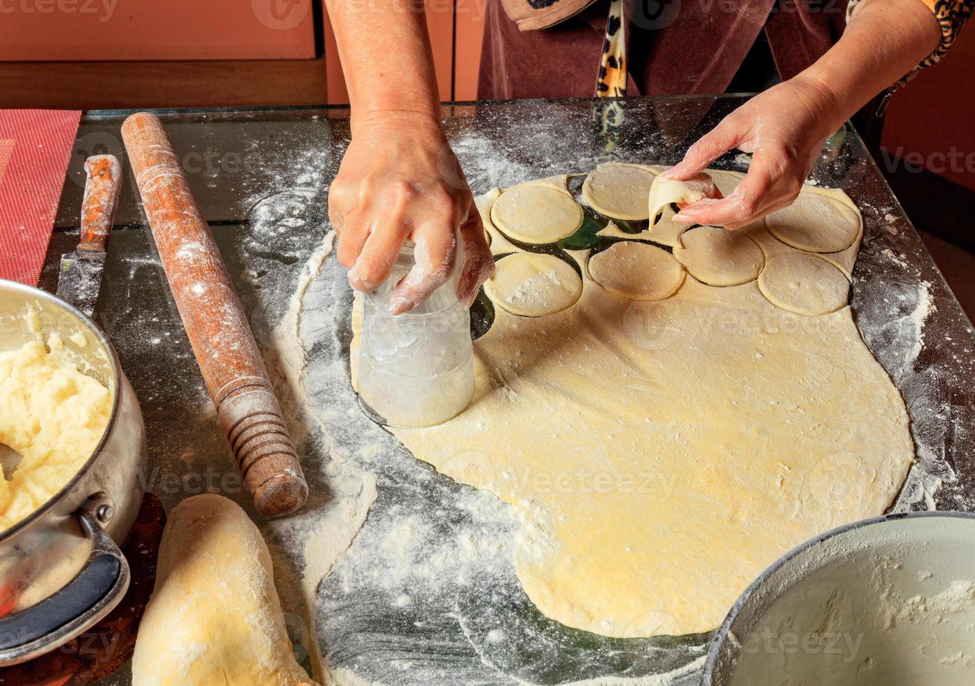 Woman molds Ukrainian dumplings. Ukrainian traditional cuisine. photo