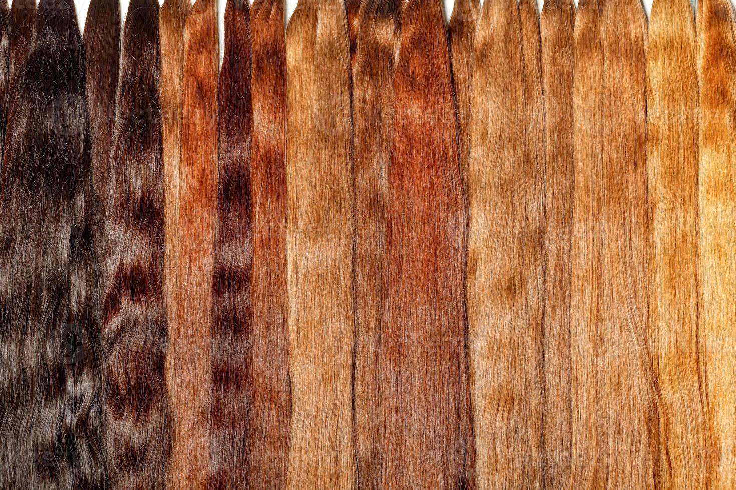 Healthy natural hair bundles from dark chocolate to light wheat color, shiny. photo