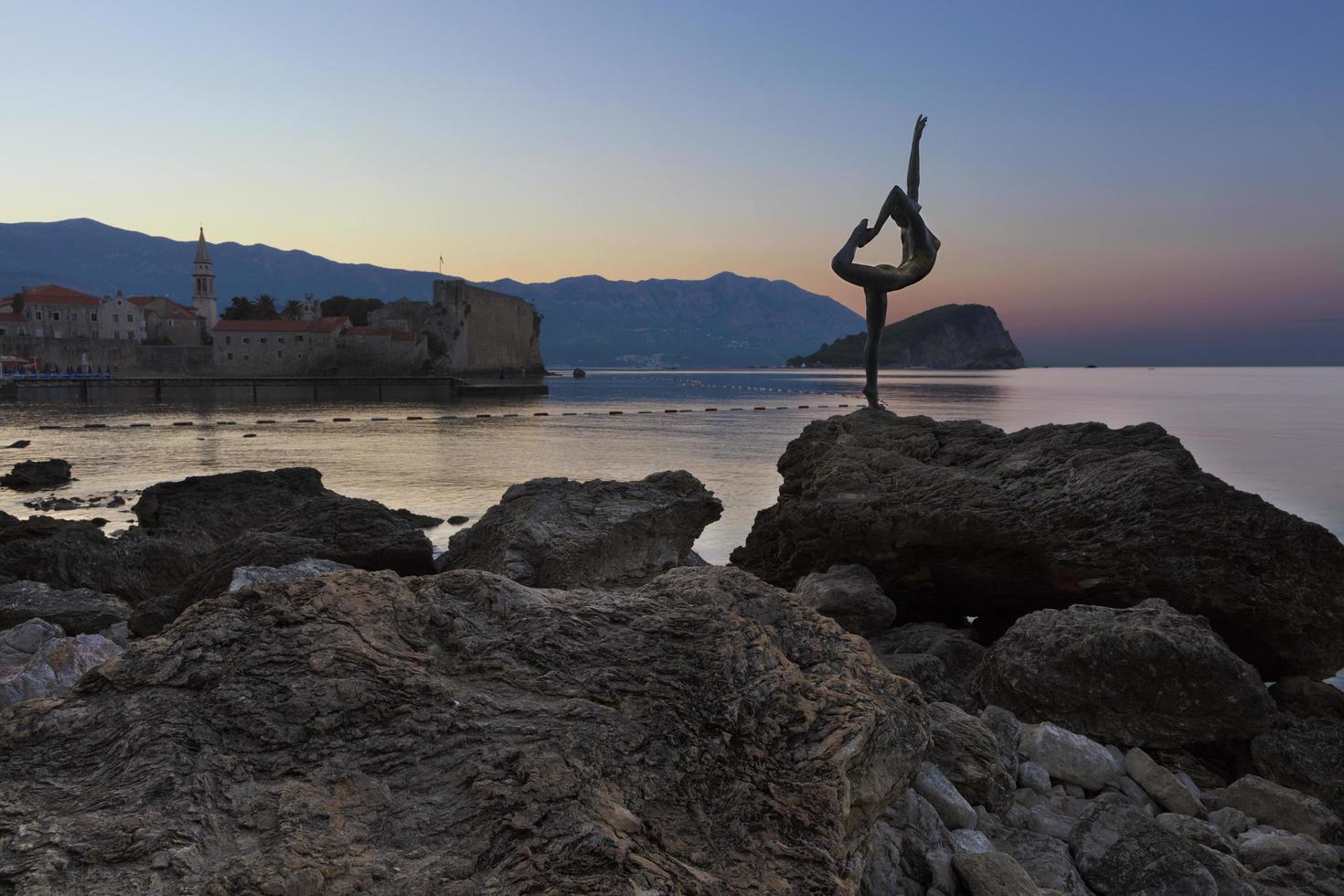 The statue of Ballerina Dancer, standing on the rock. Budva, August 2018. photo