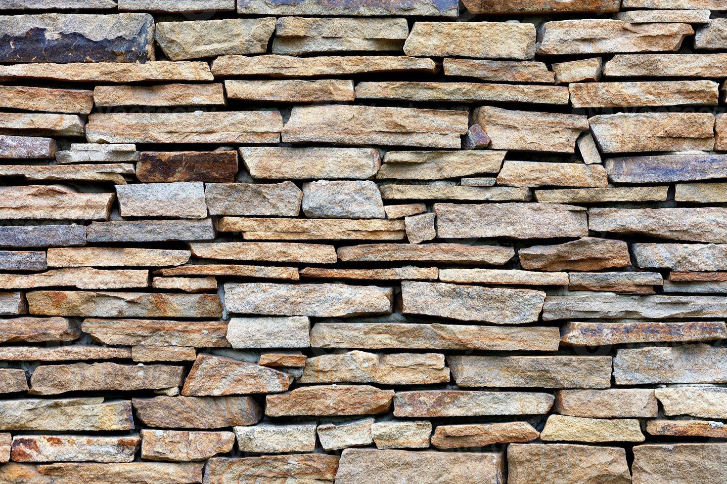 Sandstone stone wall mosaic, texture and background. photo