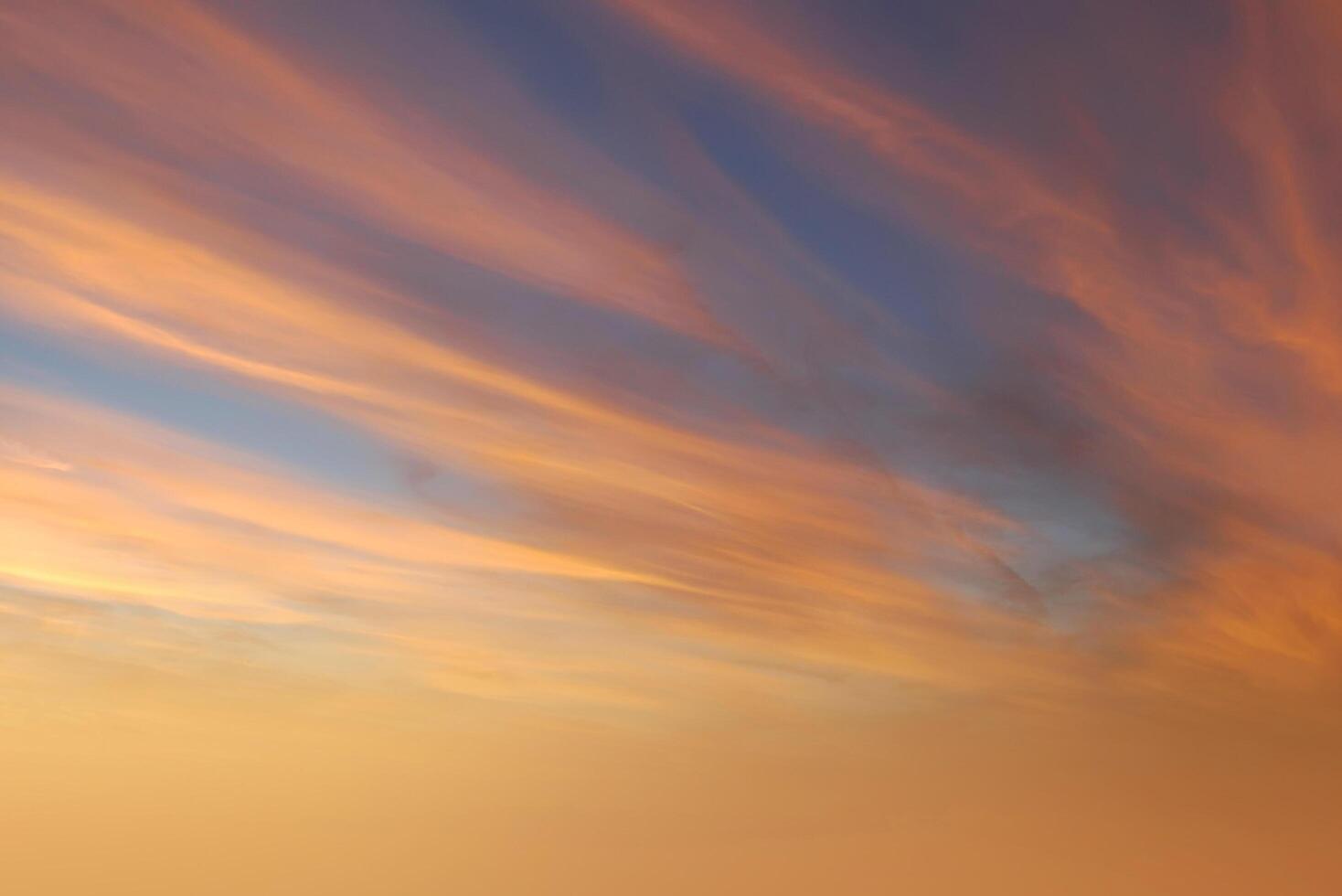 Brilliant orange sunset and sunrise beautiful over orange clouds with bright orange sun on a cool spring morning. photo