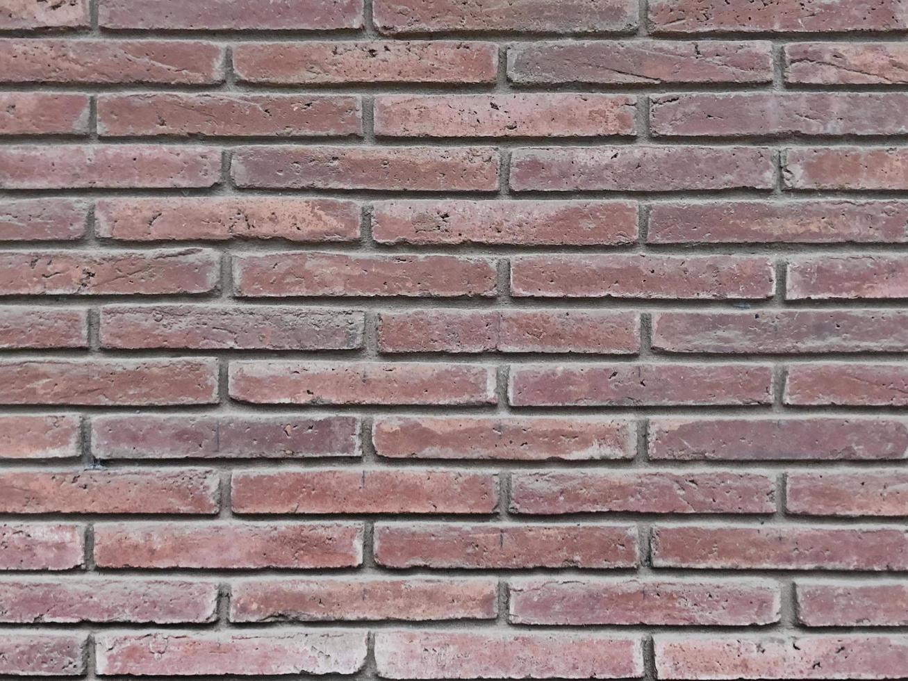 Stone wall perfectly organized,brick red and black texture from Rock wall Background Texture photo