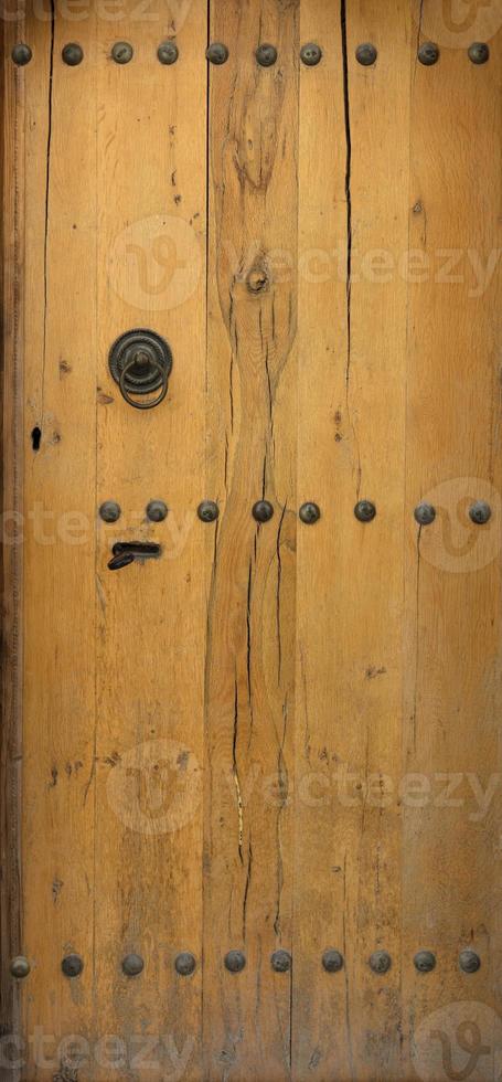 old wooden door with wrought iron rivets photo