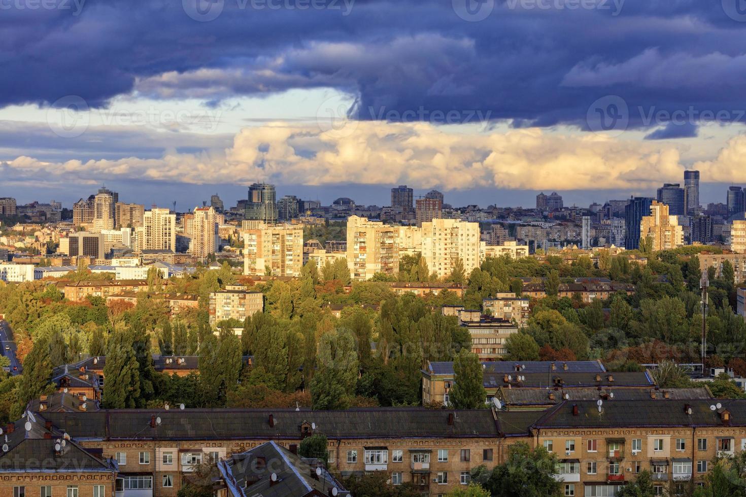 The beautiful light of the setting sun falls on the houses in the city landscape. photo