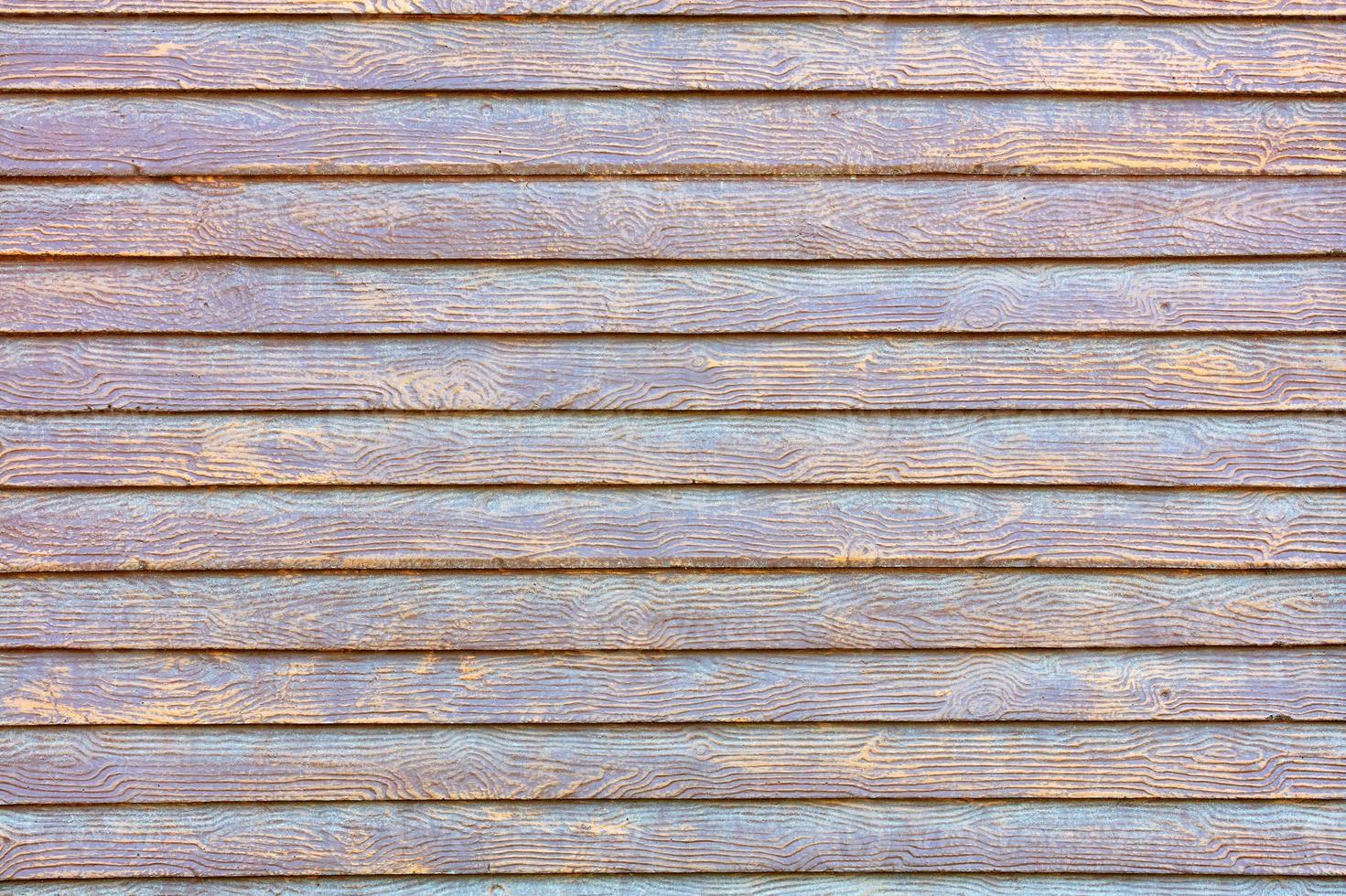 A concrete wall under the stylization of a wooden fence with smooth textured horizontal planks. photo