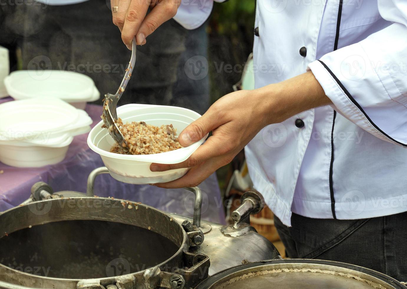 Social workers hand out porridge to poor elderly people. photo