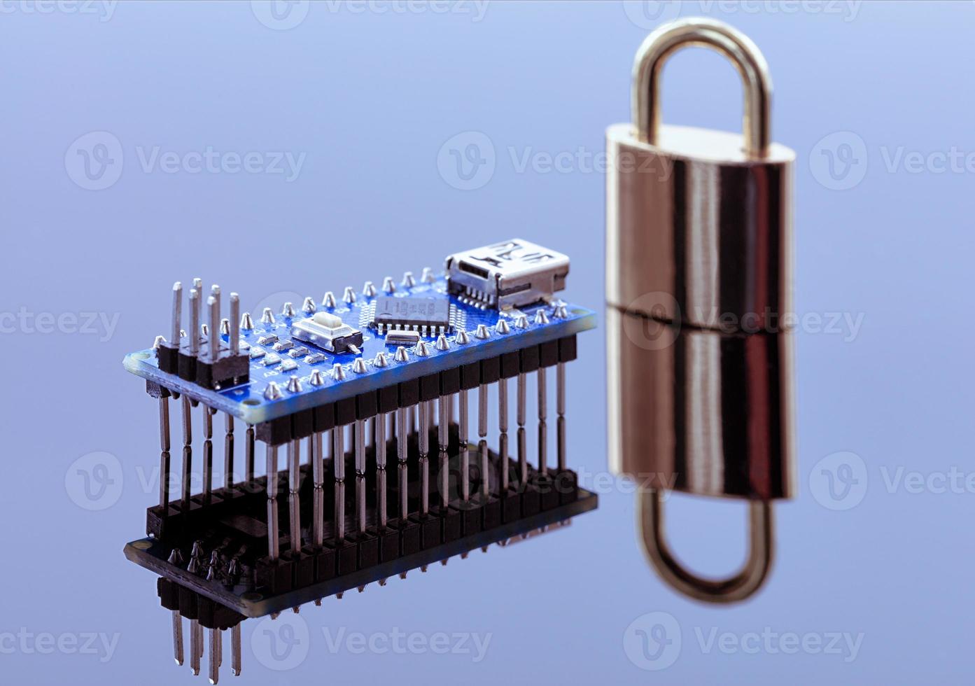 Padlock next to the computer chip - the concept of electronic data protection technology photo