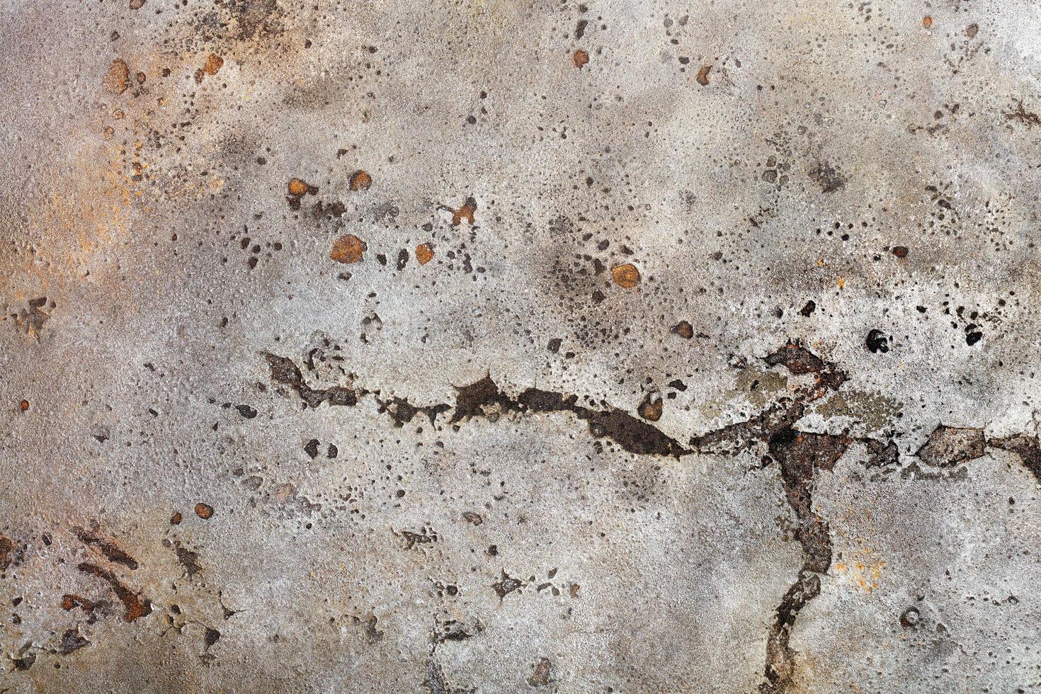 The texture of old weathered paint on a metal sheet with rusty spots, gouges and cracks. photo