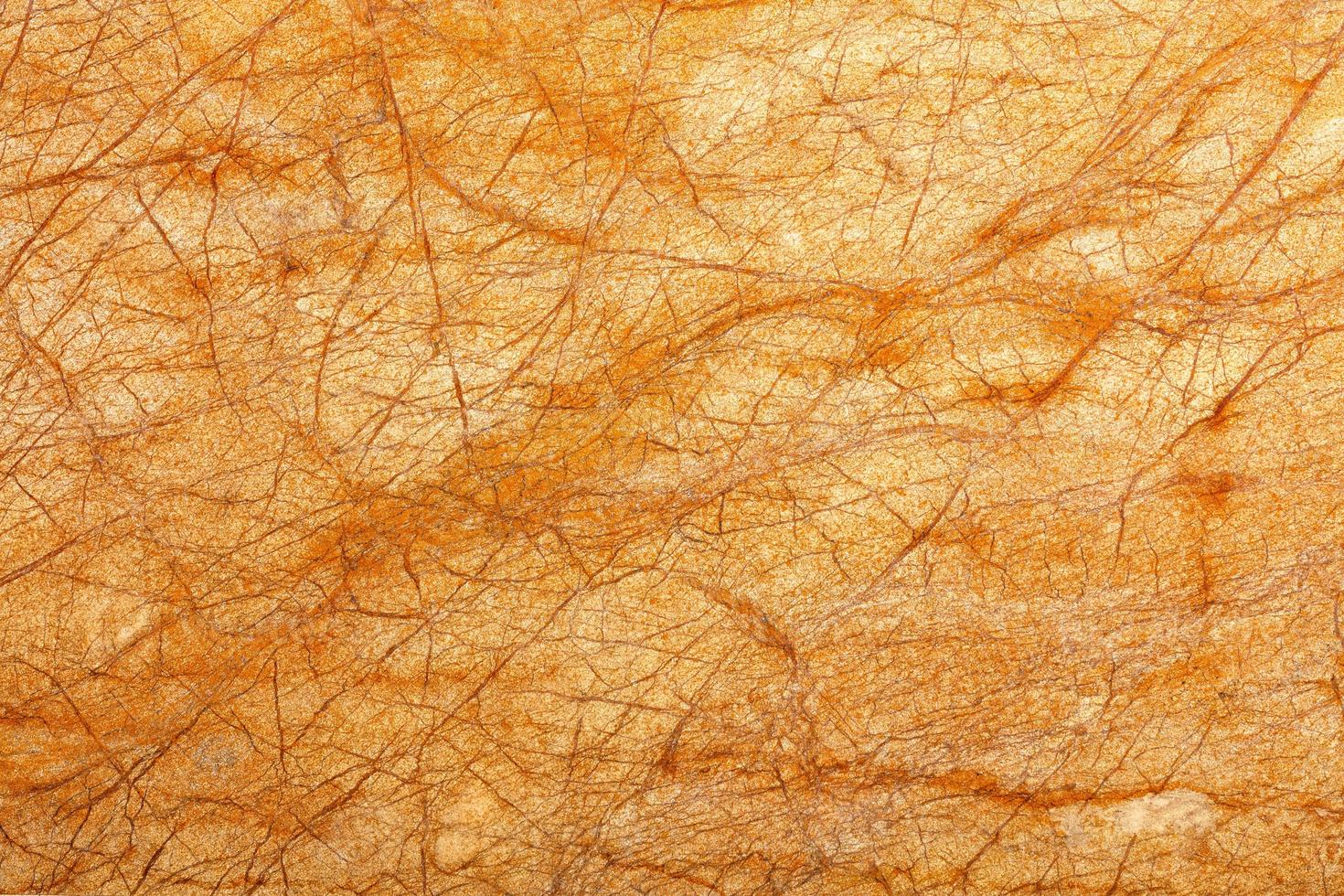 Bright orange glowing marble texture and diagonal brown cracks background. photo