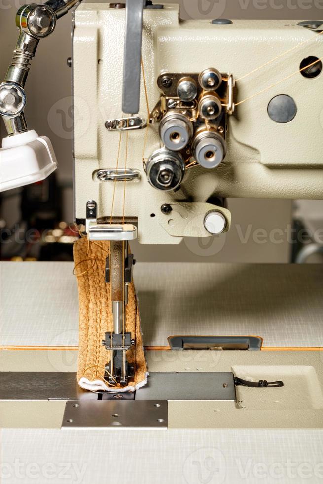 Working part of industrial sewing machine for the manufacture of furniture upholstery, closeup. photo