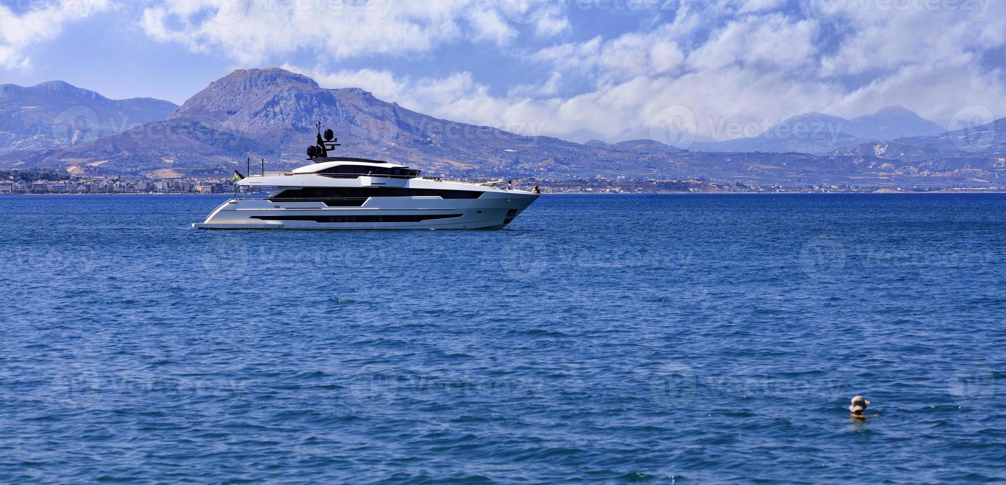 Silhouette of a marine yacht in the Corinthian bay against the backdrop of a mountain range in the morning haze. photo