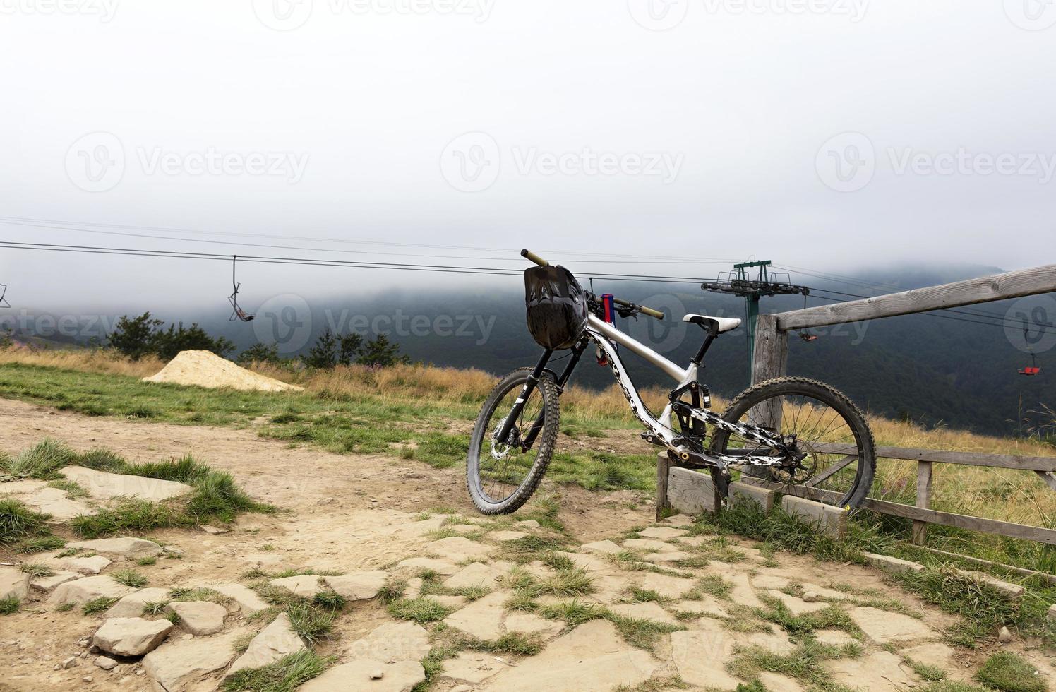 Mountain biking stands next to the railing after a quick trip photo