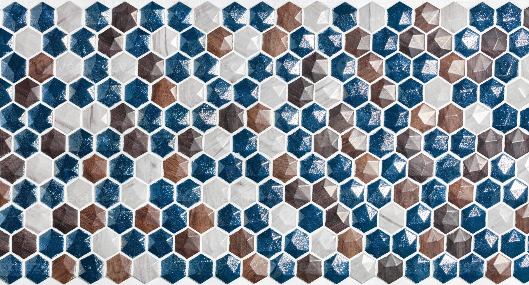 Panel of a hexagonal mosaic made of natural polished stone figurines. photo