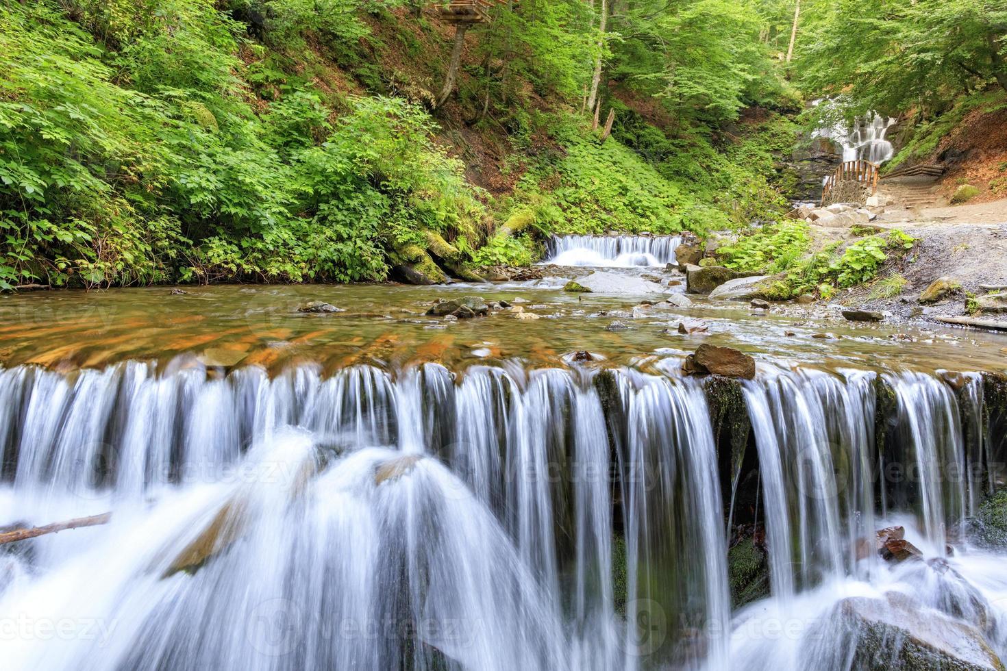 Picturesque and beautiful cascade waterfall of a mountain river in the Carpathians. photo