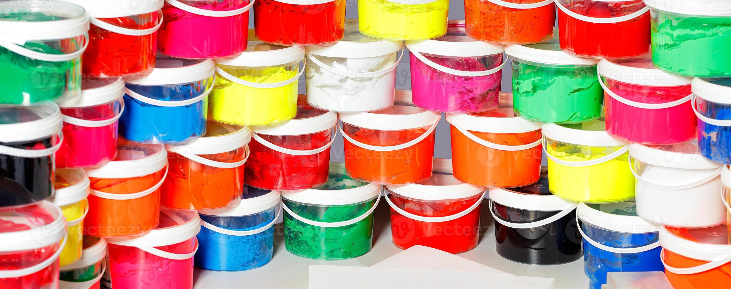 Ink for screen printing in various bright colors in transparent plastic containers lined with panoramic wide semicircle. photo