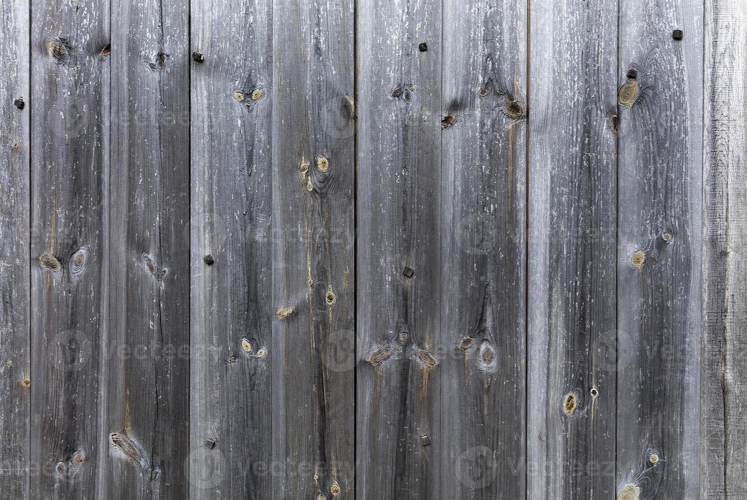 Weathered old gray wooden fence close-up photo