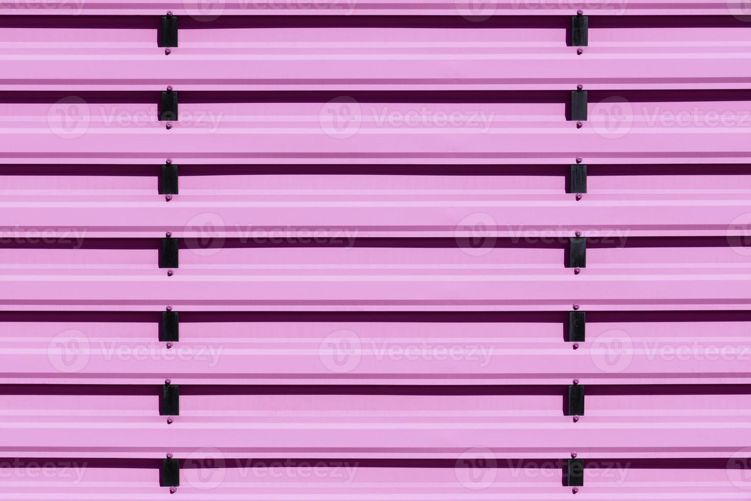 Pink metal protective fence with vertical guides. photo