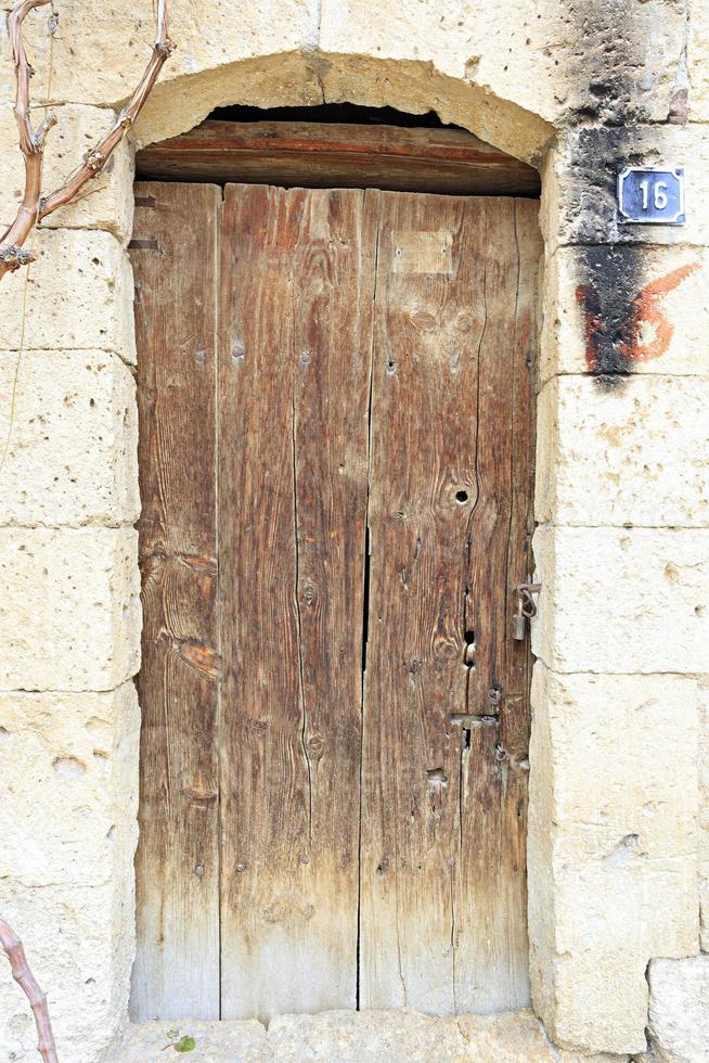 Very old wooden door with wrought-iron locks photo