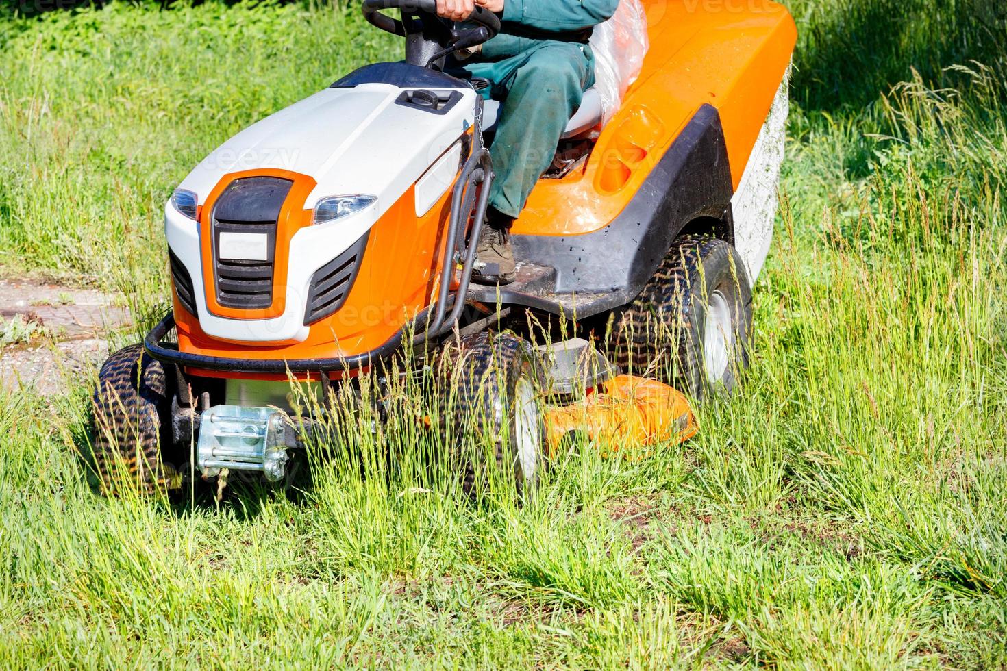 Tractor lawn mower is a powerful garden tool for the maintenance of large areas of park lawns. photo