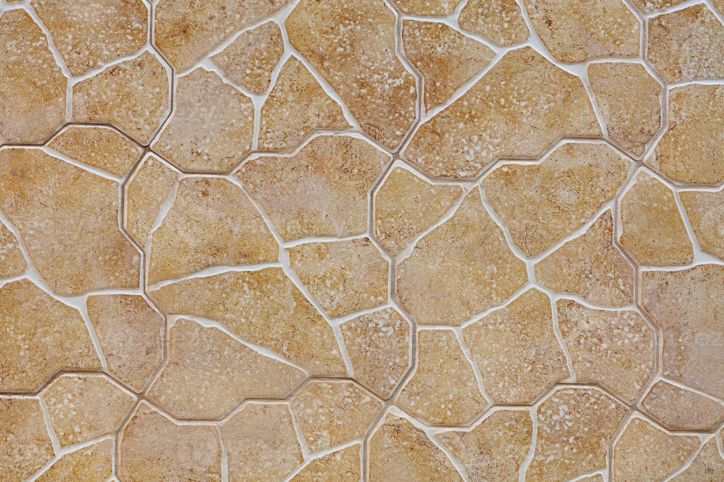Limestone stone wall texture and background, beige golden limestone building tiles. photo