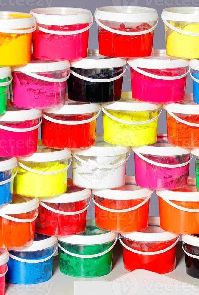 Ink in a variety of vibrant colors for printing in clear plastic containers stacked on top of each other. photo